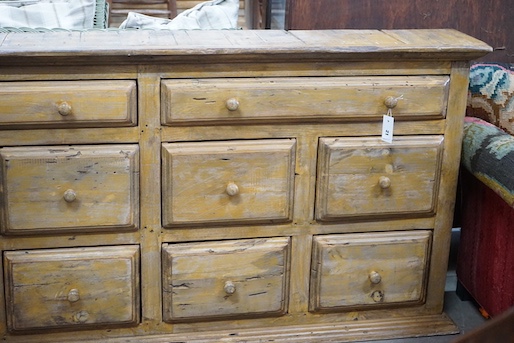 A 19th century style provincial bank of ten painted pine drawers, width 179cm, depth 26cm, height 85cm